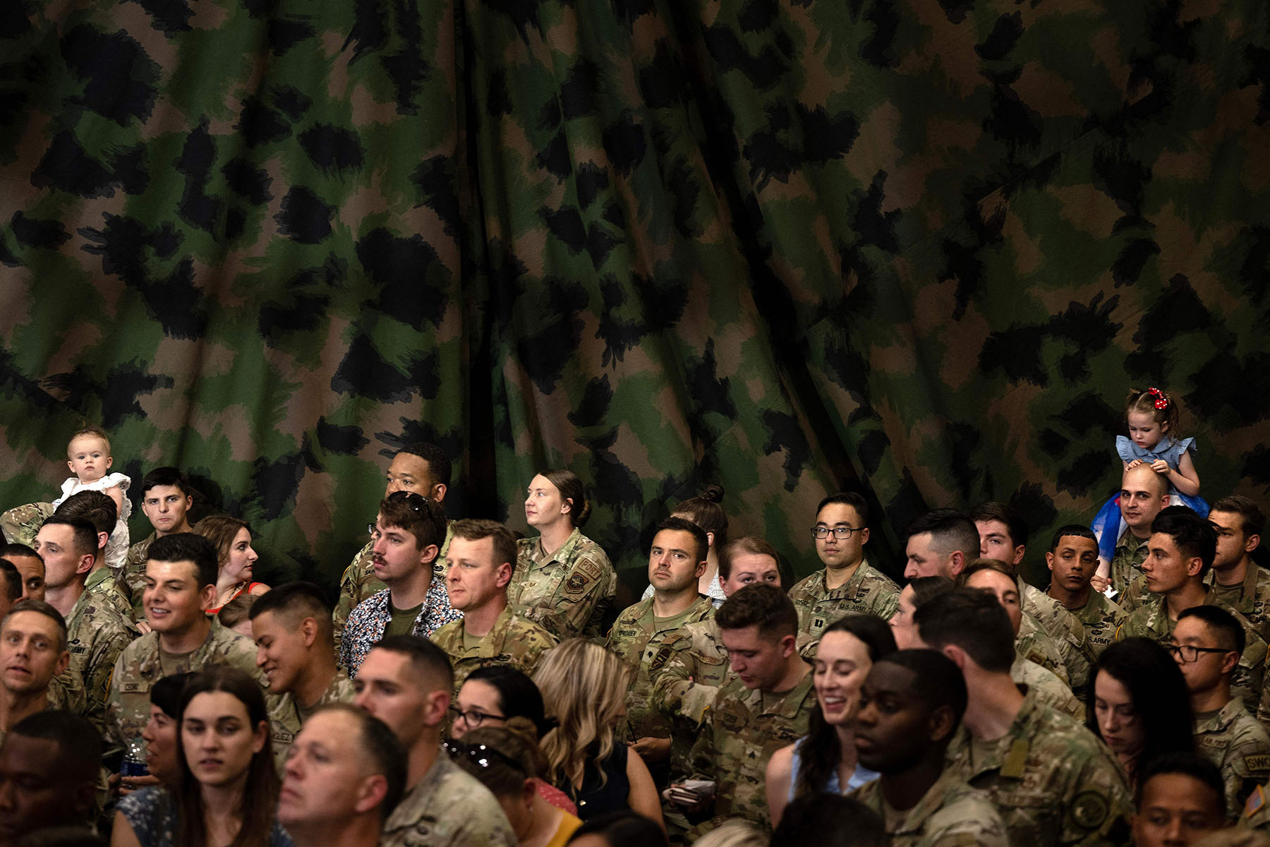 Military personnel and their families wait for President Biden to speak at Fort Liberty.