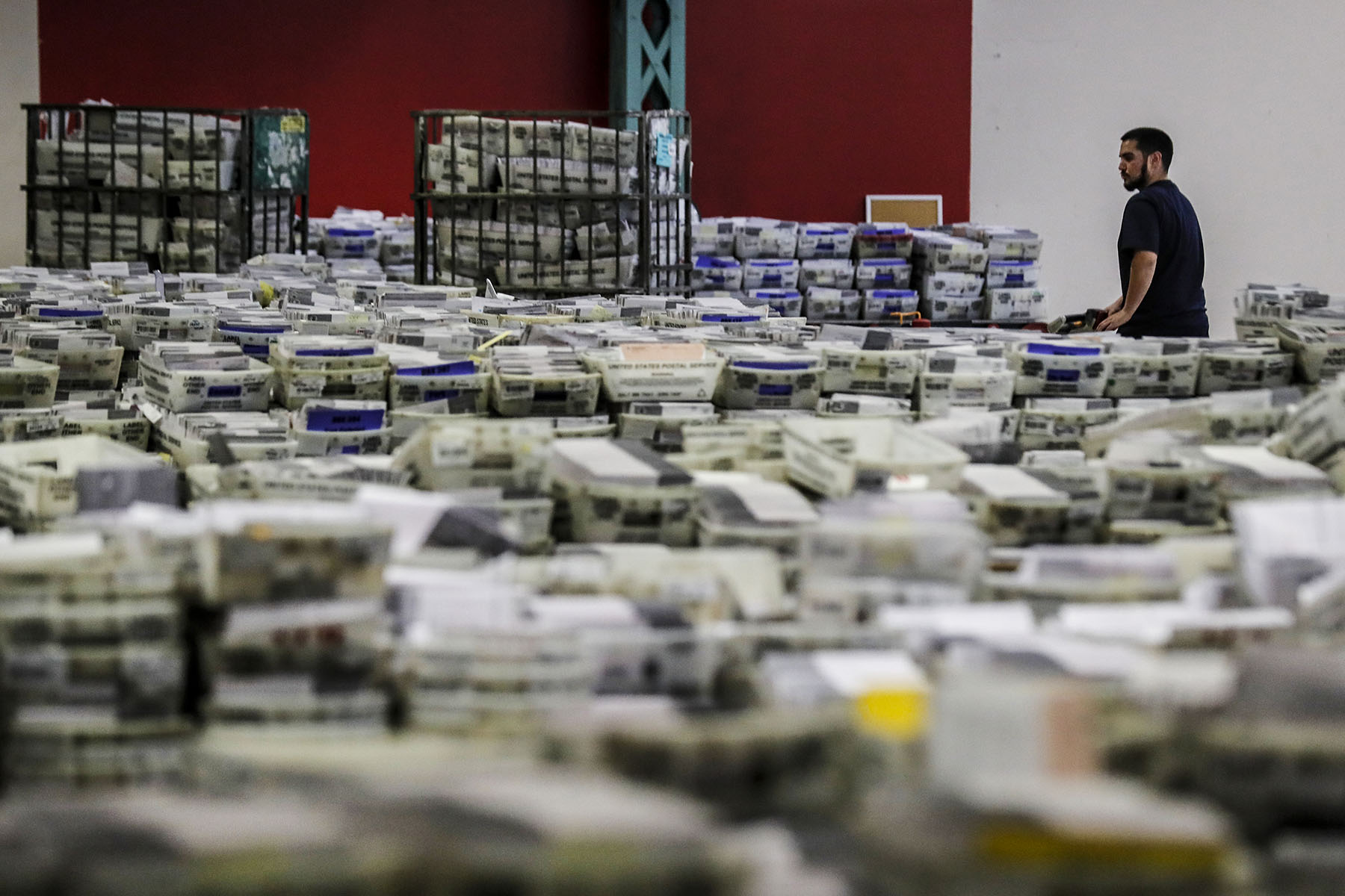 Hundreds of thousands of ballots received from drop boxes await processing at the LA county ballot processing facility.