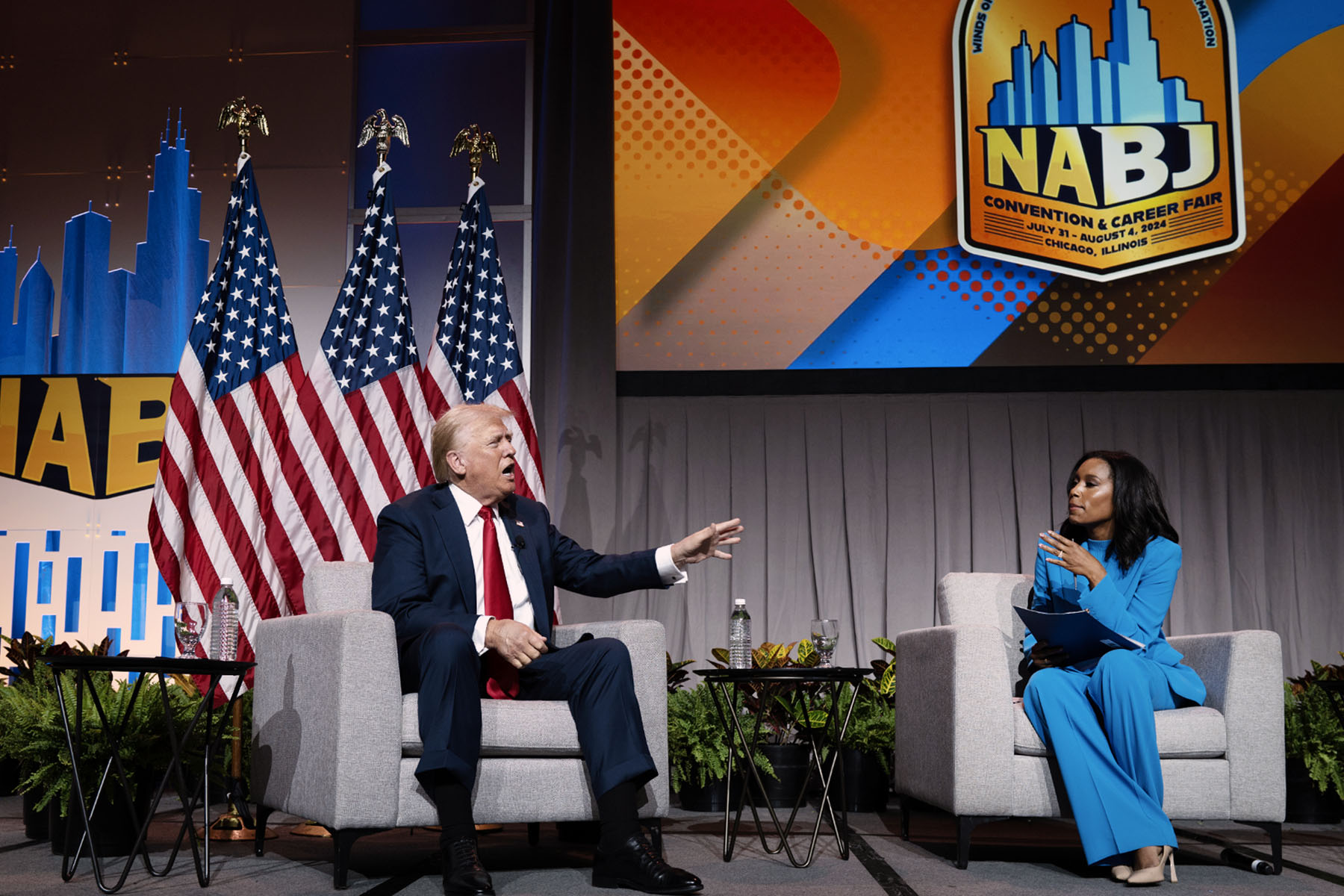 Former President Donald Trump speaks with ABC journalist Rachel Scott on stage at the National Association of Black Journalists convention's yearly convention.