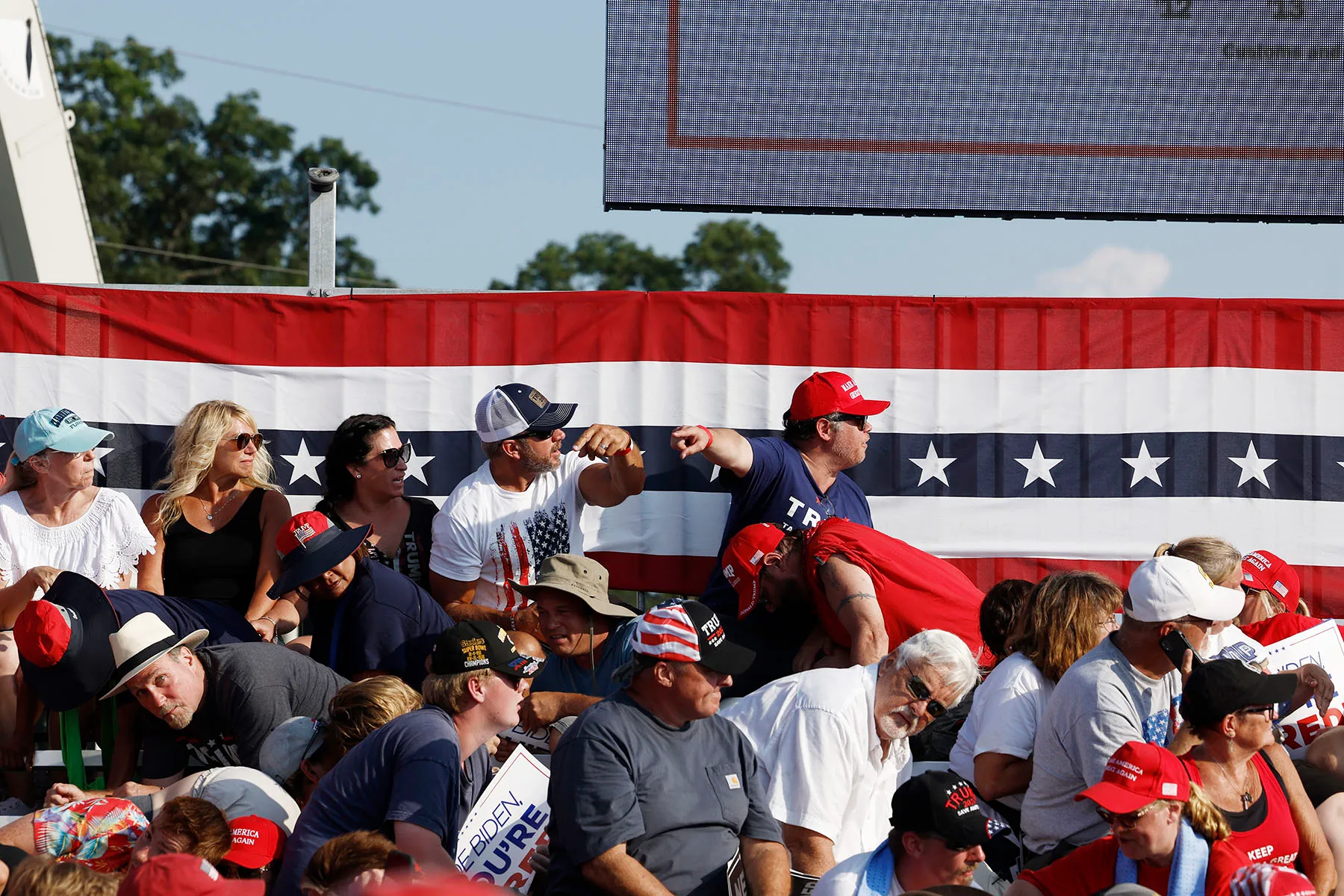 The crowd reacts after shots were fired at former President Donald Trump's rally on July 13, 2024 in Butler, Pennsylvania.