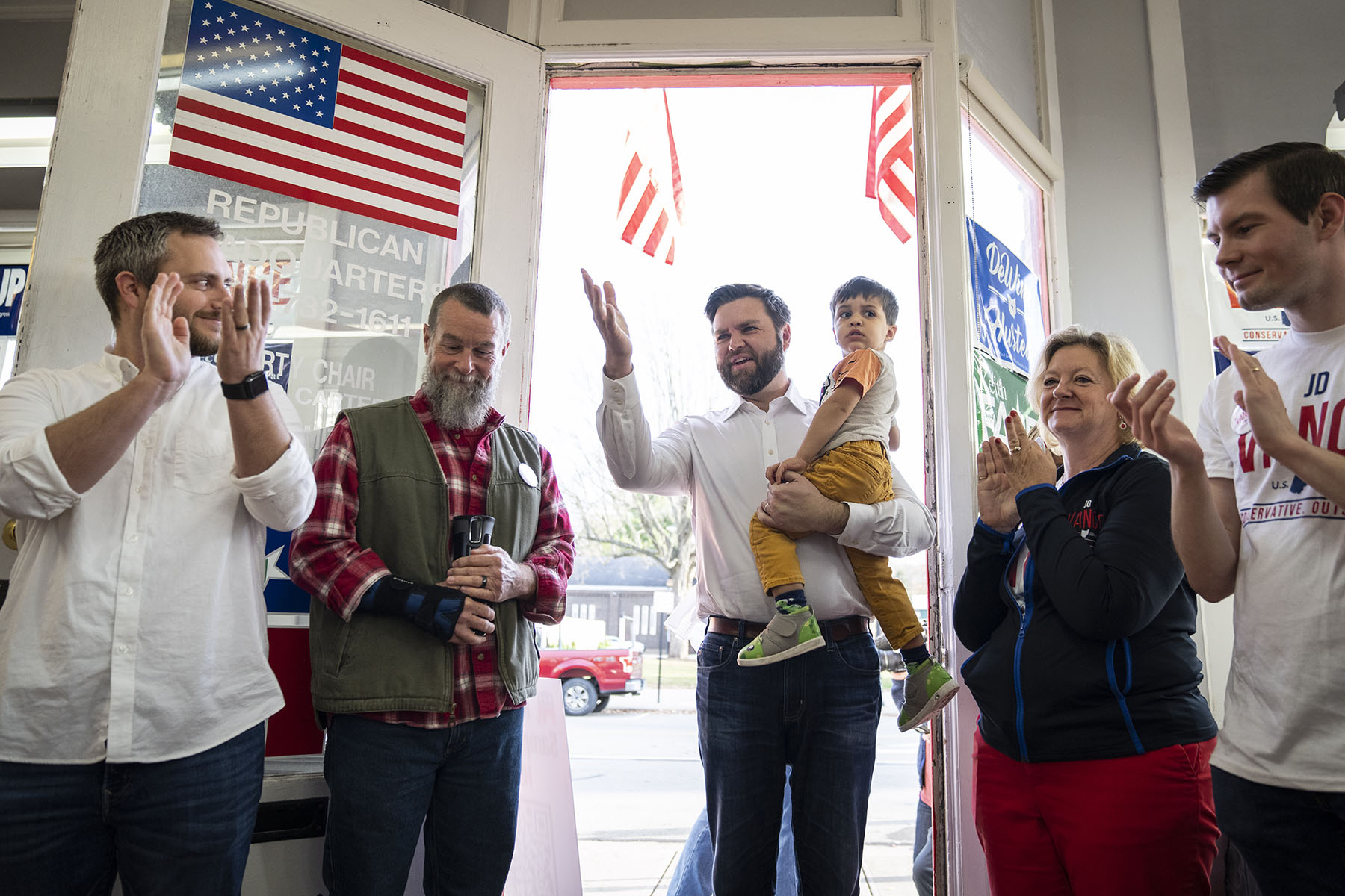 JD Vance holds his son Vivek as he arrives at a get-out-the-vote rally.