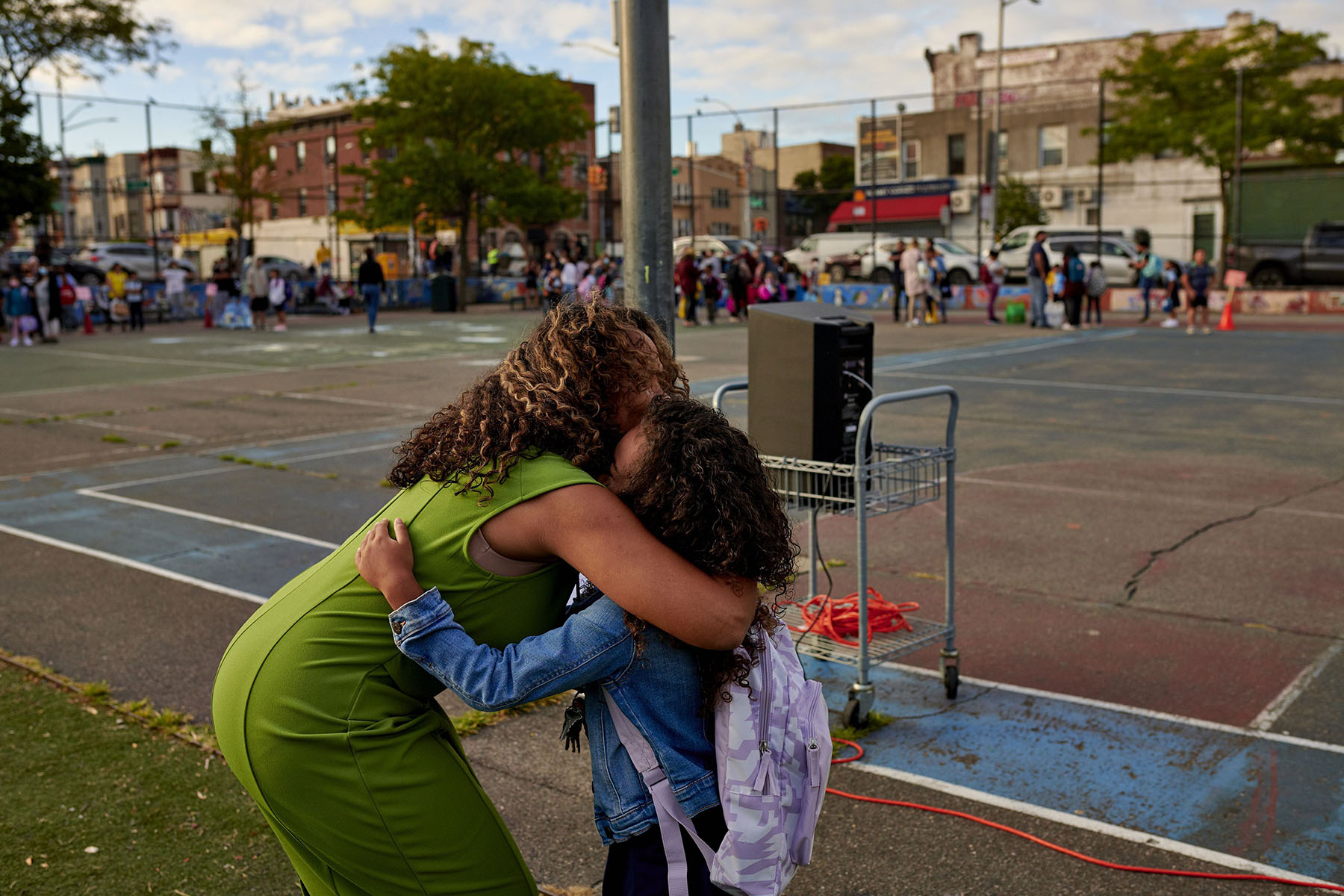 A first grader receives a hug outside of P.S. 503 in Brooklyn, New York, on the first day of school.