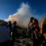 Residents watch as the Sheep fire burns in Wrightwood, Calif., Sunday, June 12, 2022.