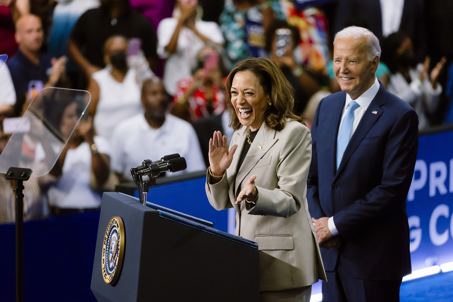 Vice President Kamala Harris speaks while President Joe Biden listens at an event at Prince George's Community College.