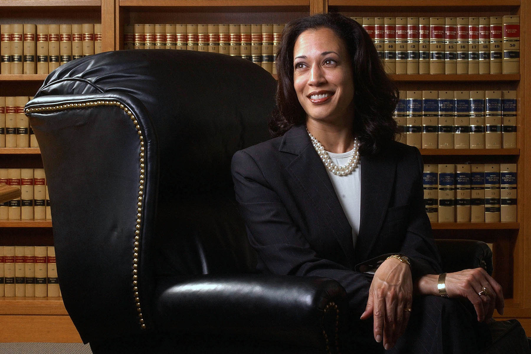 Kamala Harris poses for a portrait in front of law books.