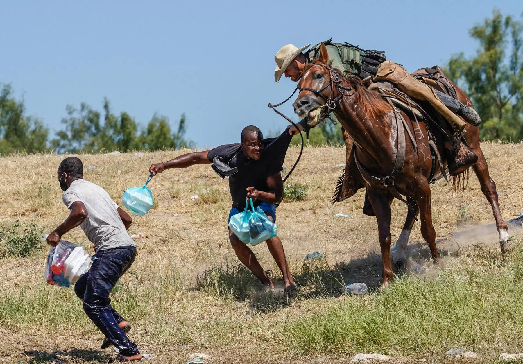 A United States Border Patrol agent on horseback tries to stop a Haitian migrant from entering an encampment on the banks of the Rio Grande near the Acuna Del Rio International Bridge in Del Rio, Texas on September 19, 2021. The United States said Saturday it would ramp up deportation flights for thousands of migrants who flooded into the Texas border city of Del Rio, as authorities scramble to alleviate a burgeoning crisis for President Joe Biden's administration.