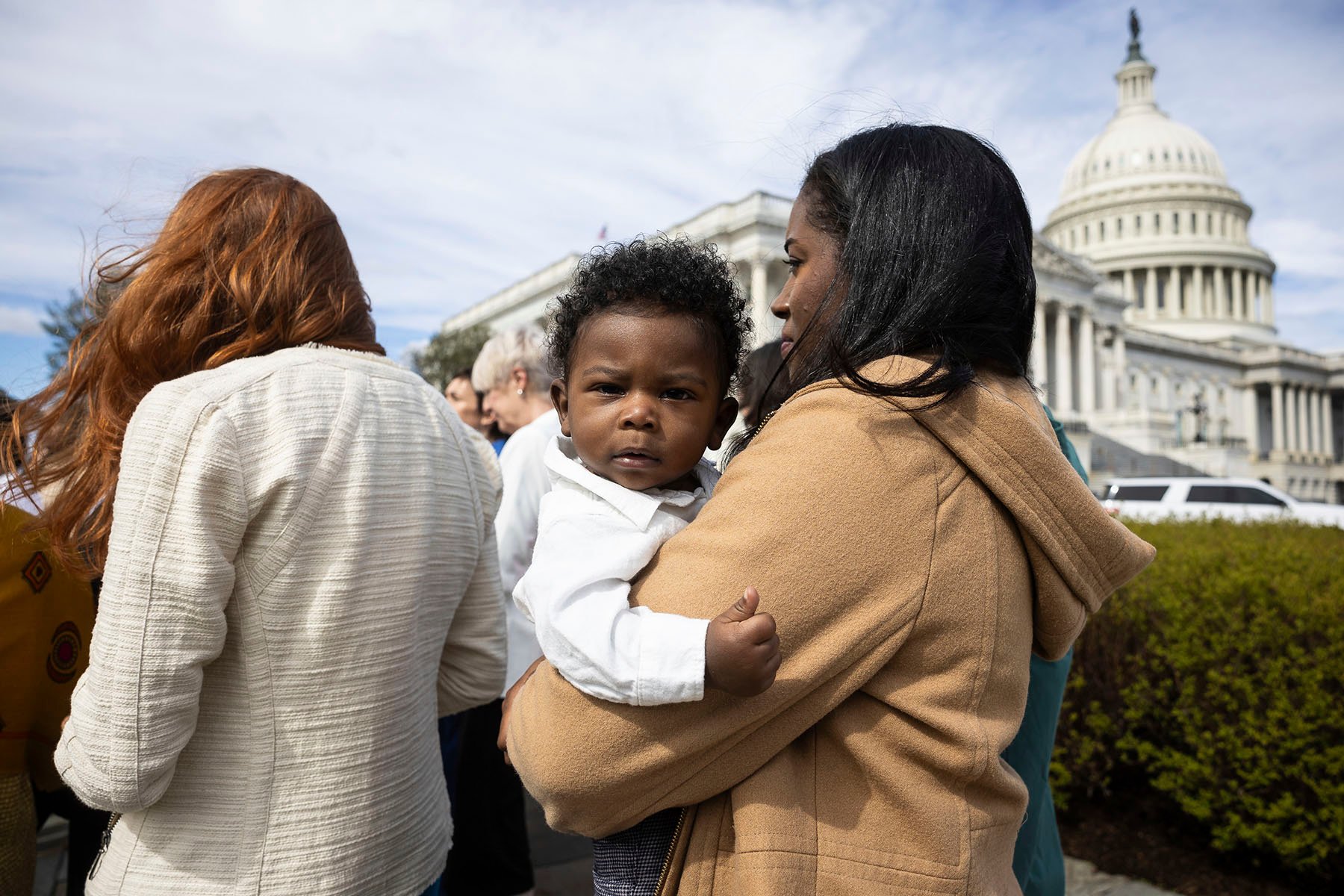 Kaitlyn Joshua holds her son, Liam Joshua, during a press conference with Democratic lawmakers on reproductive freedom outside the Capitol.