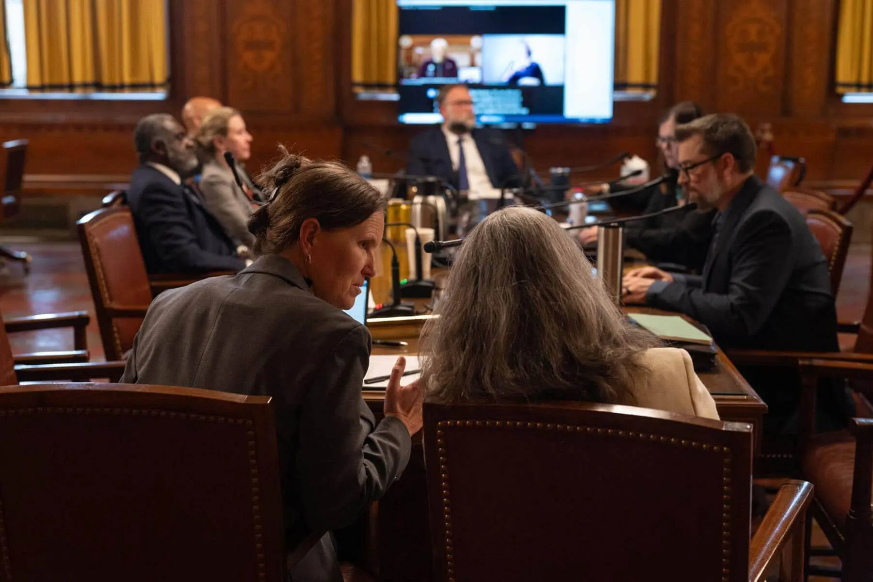 Pittsburgh City Councilors Barb Warwick, left, and Deb Gross talk during a public hearing on April 10, at the City-County Building.