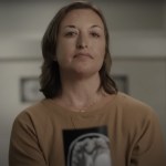Portrait of a woman holding an MRI scan.
