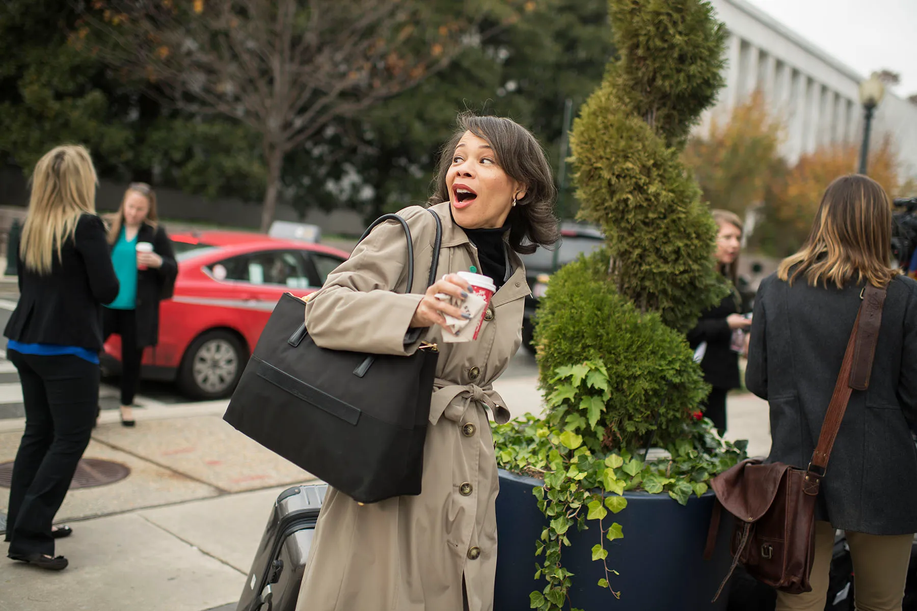 Lisa Blunt Rochester, carrying a coffee and a suitcase, arrives to the Capitol Hill Hotel on the day freshman members check in for orientation.