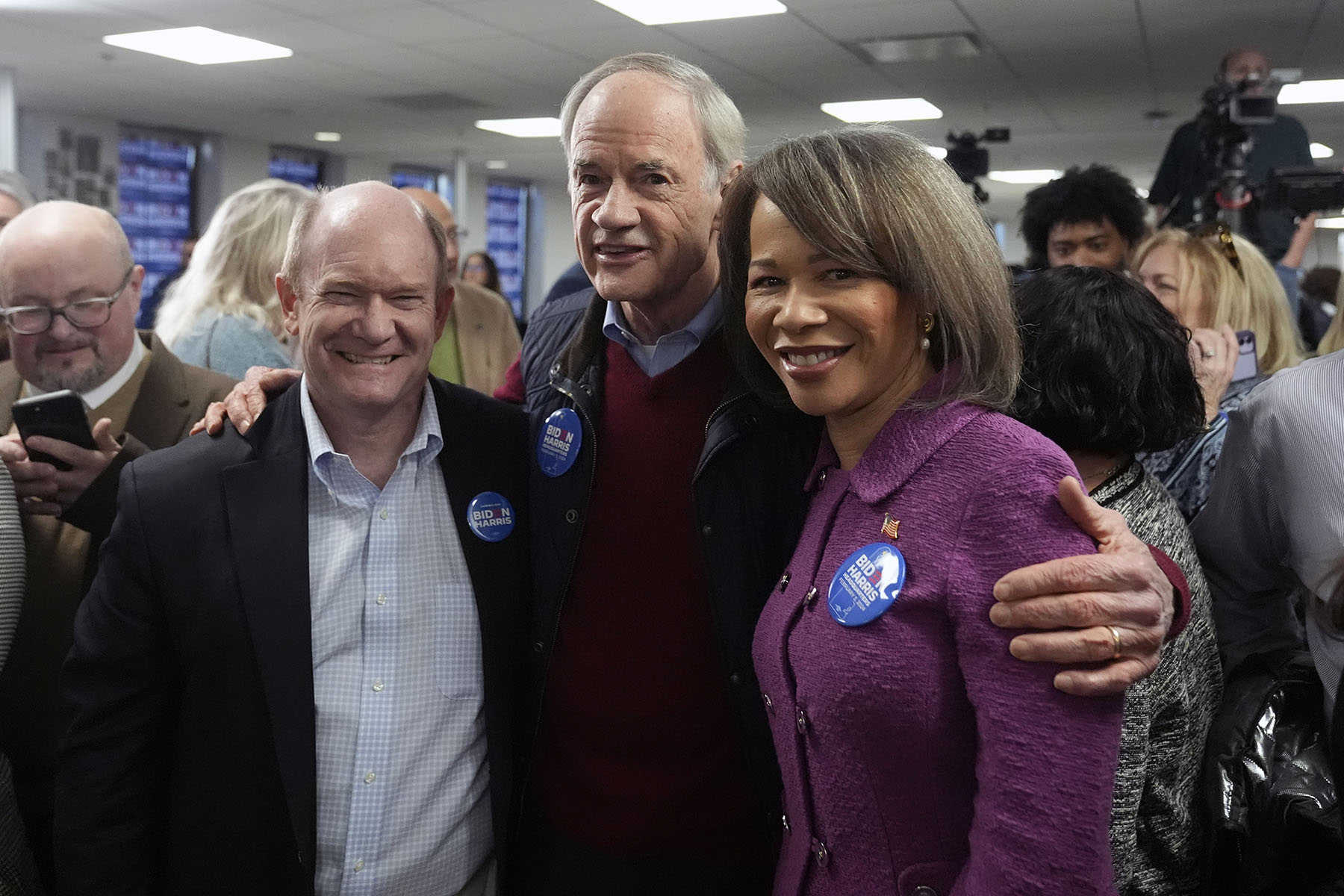 From left, Sen. Chris Coons, Sen. Tom Carper, and Rep. Lisa Blunt Rochester pose for a photo together before President Joe Biden speaks at the Biden campaign headquarters.