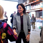 Republican gubernatorial candidate Kelly Ayotte shakes hands with administrators during a visit to a local concrete coating business.