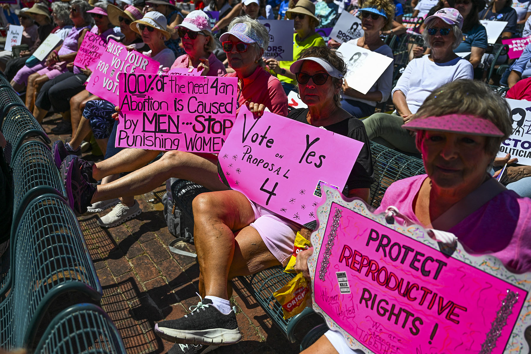 Activists holding pink signs participate in the "Rally for Our Freedom" to protect abortion rights in Orlando, Florida, on April 13, 2024.