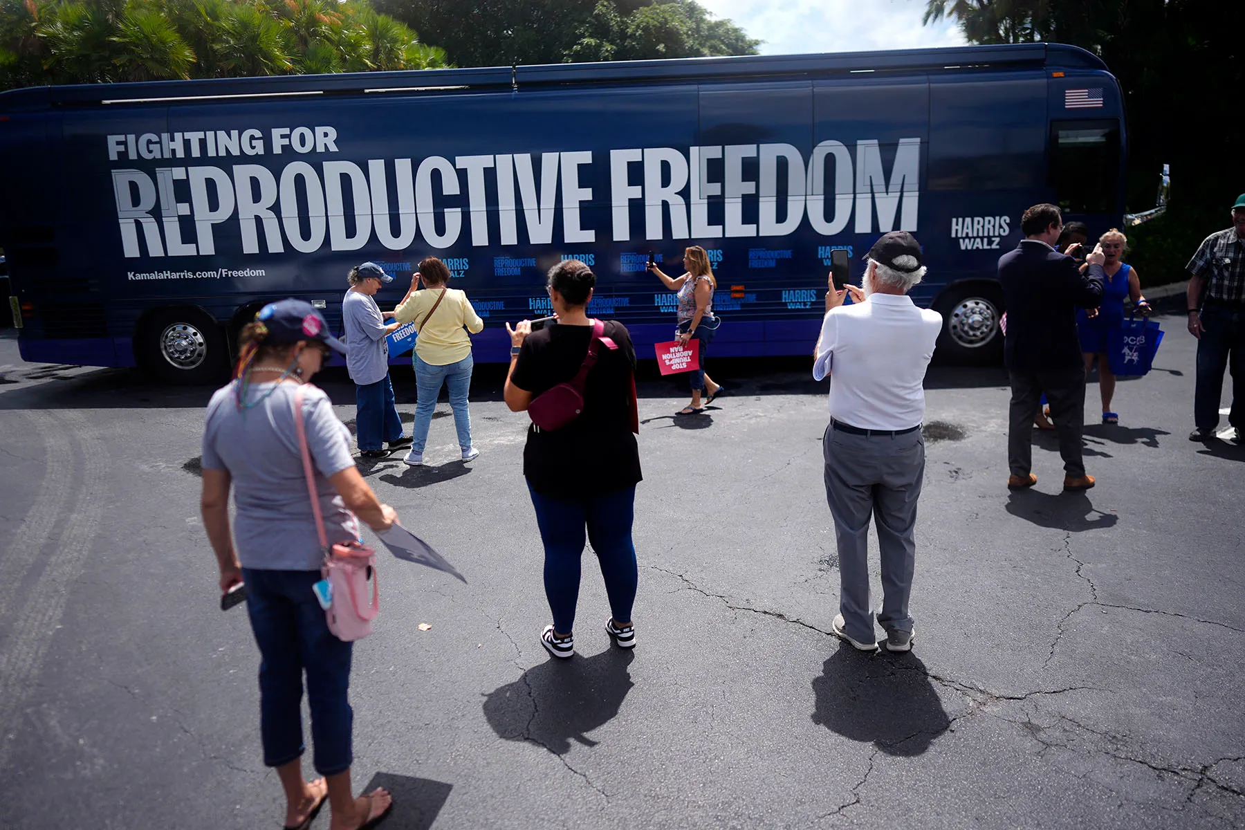 People gather around and take pictures of the "Reproductive Freedom Bus Tour" bus in Boynton Beach, Florida, on September 3, 2024.