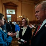Georgia state election board members Sara Tindall Ghazal, Janice Johnston and Executive Director Mike Coan speak ahead of a Georgia state election board meeting at the state capitol.