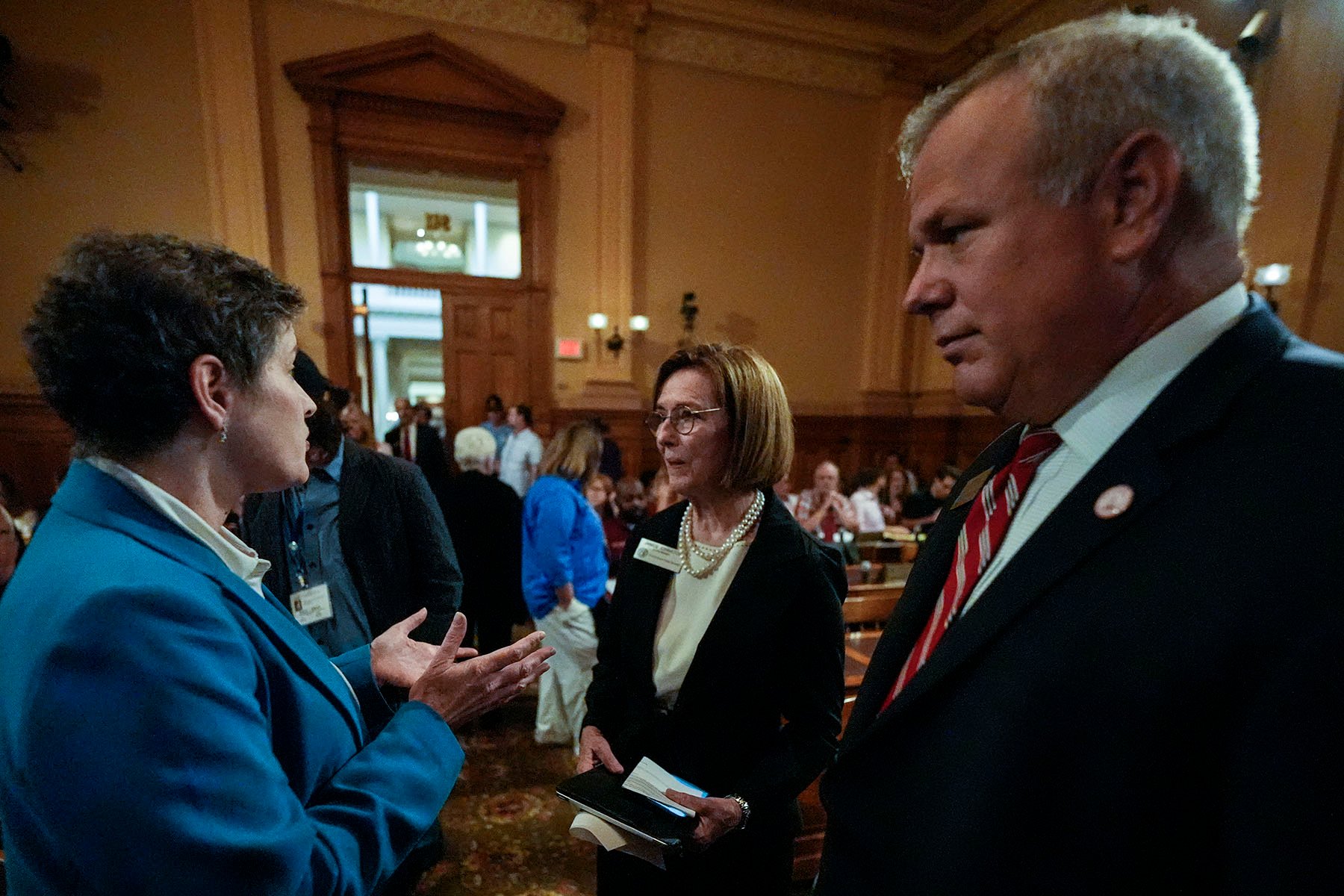 Georgia state election board members Sara Tindall Ghazal, Janice Johnston and Executive Director Mike Coan speak ahead of a Georgia state election board meeting at the state capitol.