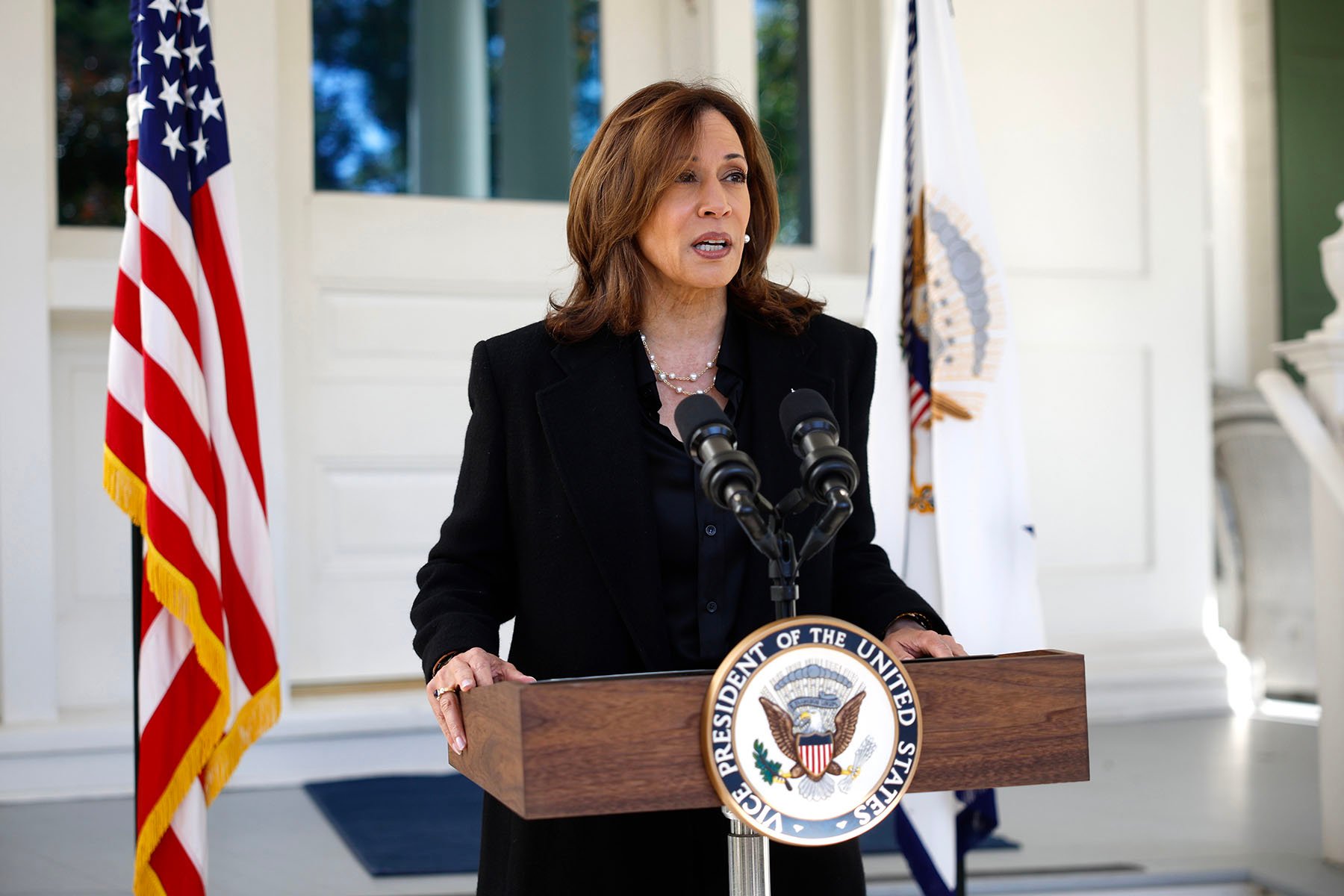 Vice President Kamala Harris stands at a podium as she delivers remarks on former White House Chief of Staff John Kelly's recent comments about former President Trump.