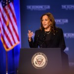 Vice President Kamala Harris speaks at a lectern with the seal of the vice president on it