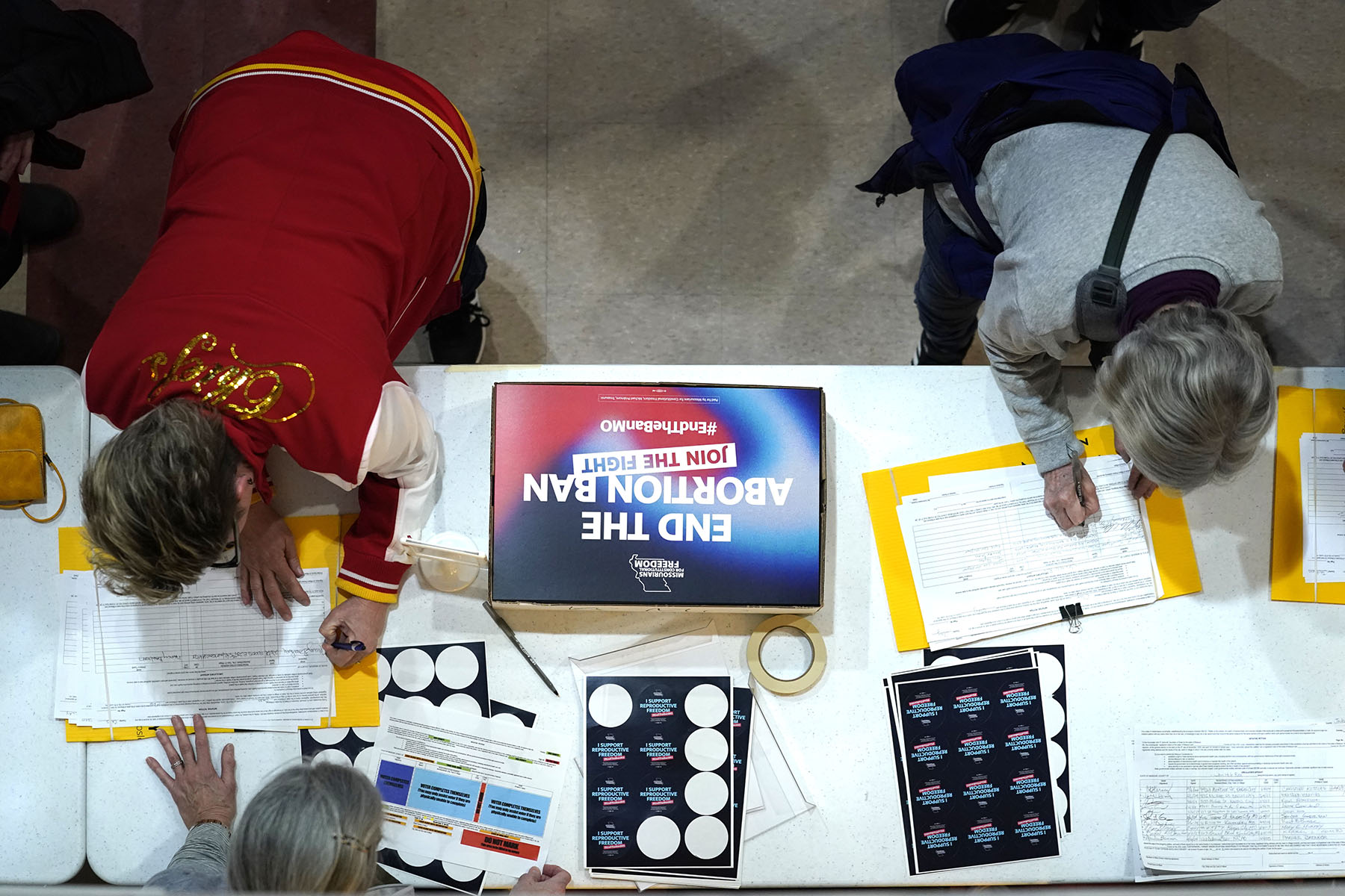 Residents place their signatures on a petition in support of a ballot initiative during Missourians for Constitutionals Freedom kick-off petition drive.