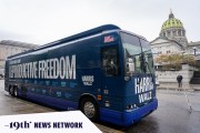 A blue Harris-Walz campaign bus with the slogan 'Fighting for Reproductive Freedom' painted on is parked outside the Pennsylvania State Capitol in Harrisburg.