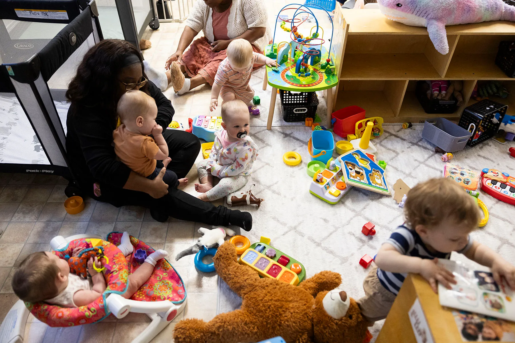 Children are being cared for by a teacher's aid at a child care center in Drexel Hill, Pennsylvania.