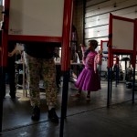 A voter fills out her ballot at a fire station while her daughter waits for her in Louisville, Kentucky.