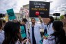 A group of doctors joins abortion rights supporters at a rally outside the Supreme Court. One holds a sign that reads 