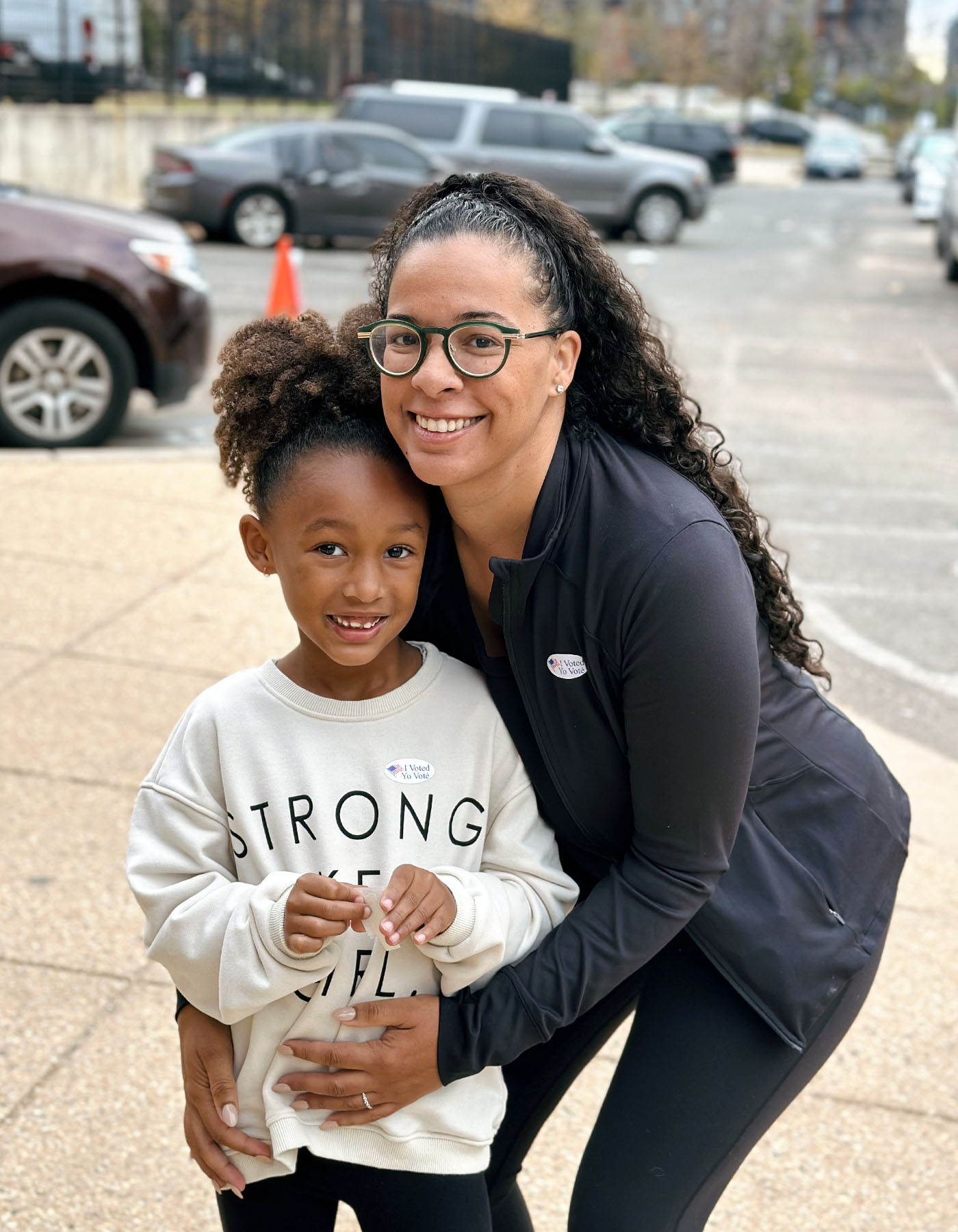 Elle Arlook smiles as she holds her 6-year-old daughter, Mariama, after voting in Washington, D.C.