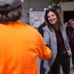 Republican gubernatorial candidate Kelly Ayotte shakes hands with a worker at a concrete coating business