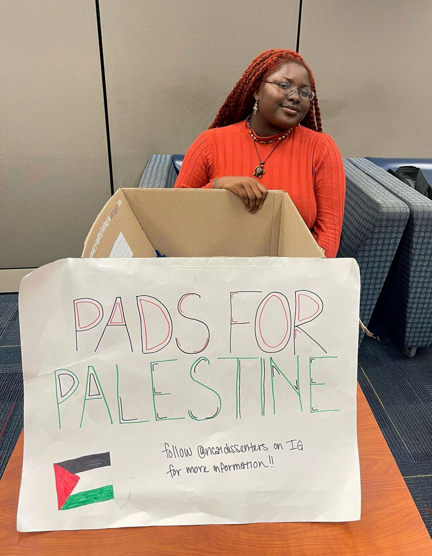 Ziora Ajeroh collects menstrual products for Palestine on campus.