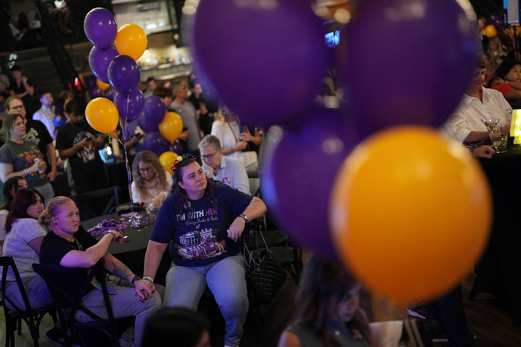 Melissa Estes holds hands with fiancé Sabrina Dennig during a watch party by advocates of Florida's Amendment 4.