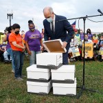 Sen. Bob Casey opens boxes of stories from home care recipients, family care givers and home care workers at a 24-hour vigil outside of the Capitol building.