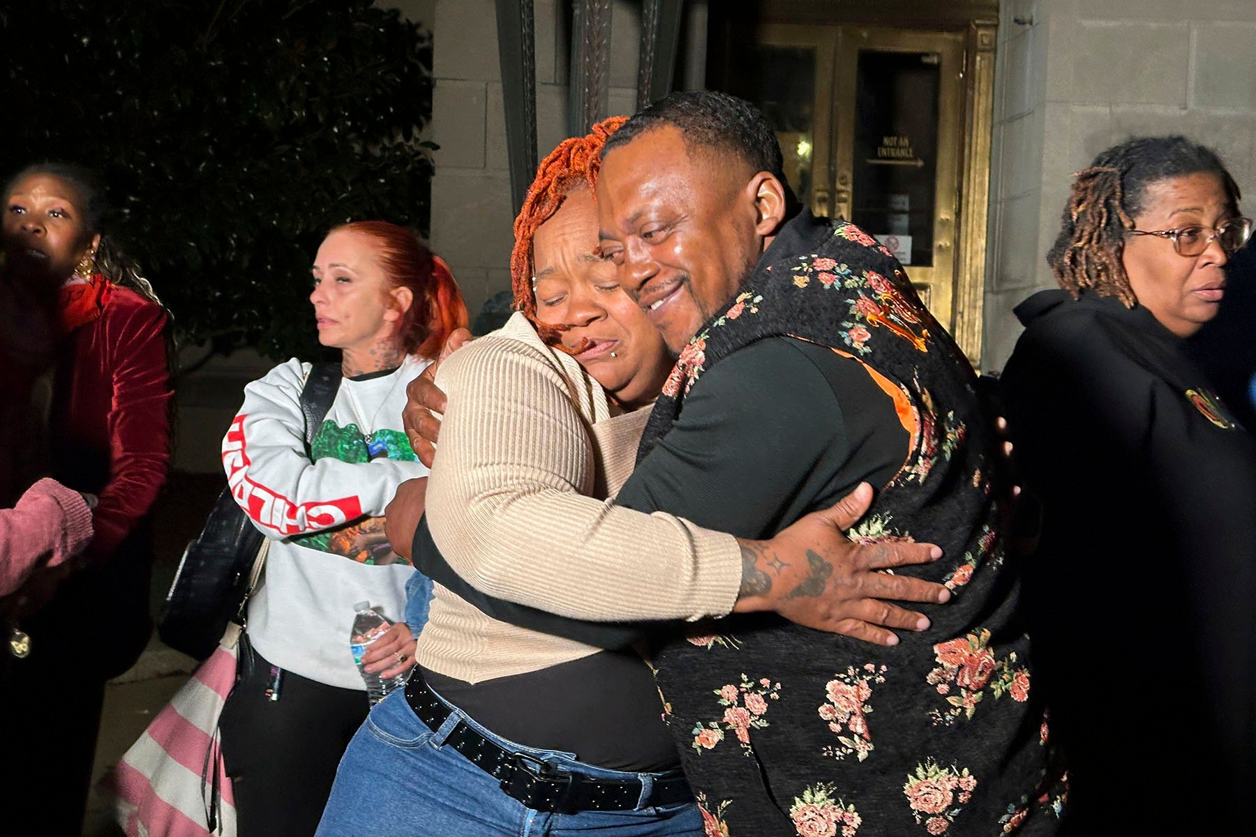 Breonna Taylor's mother, Tamika Palmer, hugs a friend in reaction to Brett Hankison's conviction in federal court.