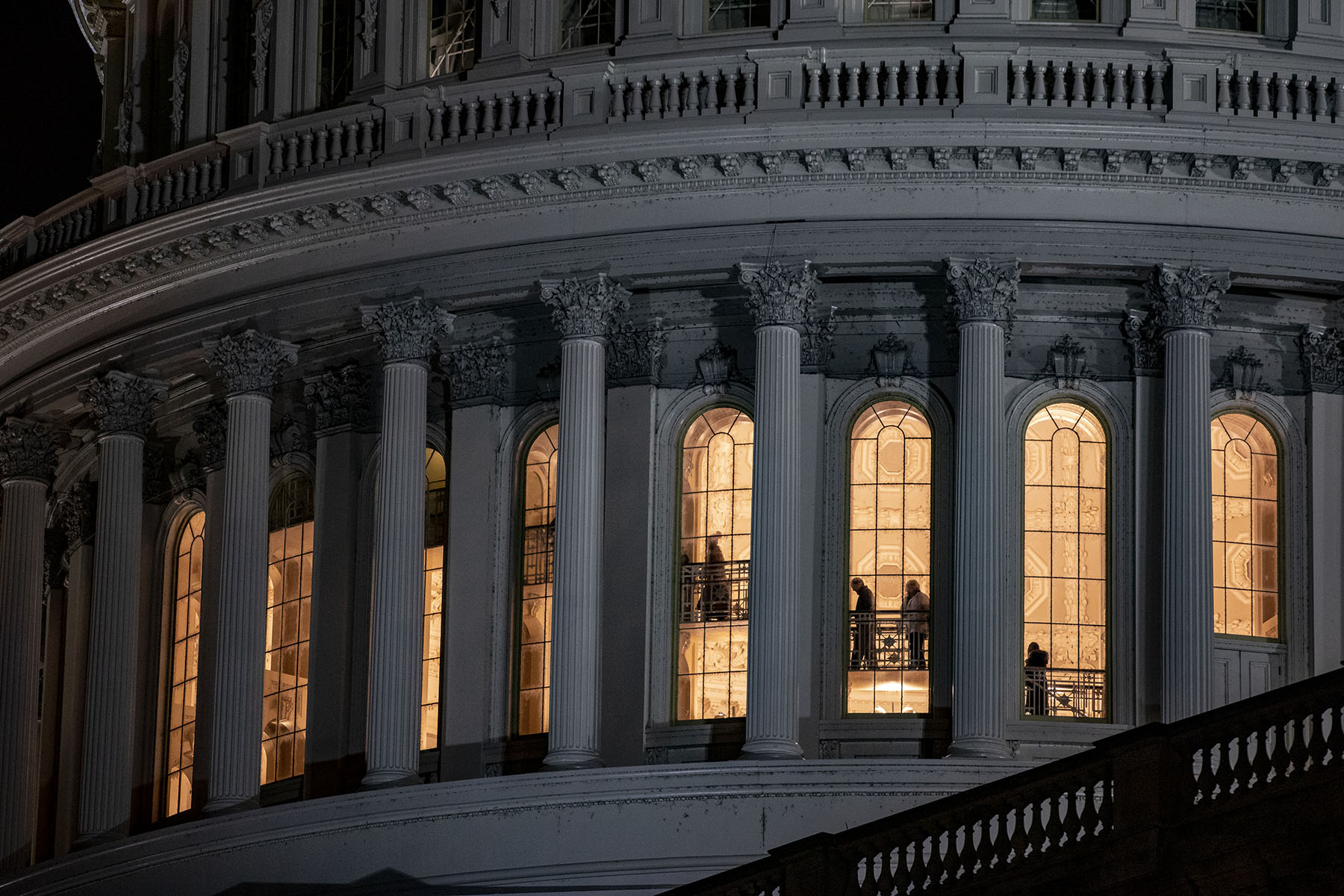 People are seen walking up stairs through windows at the top of the Capitol dome.