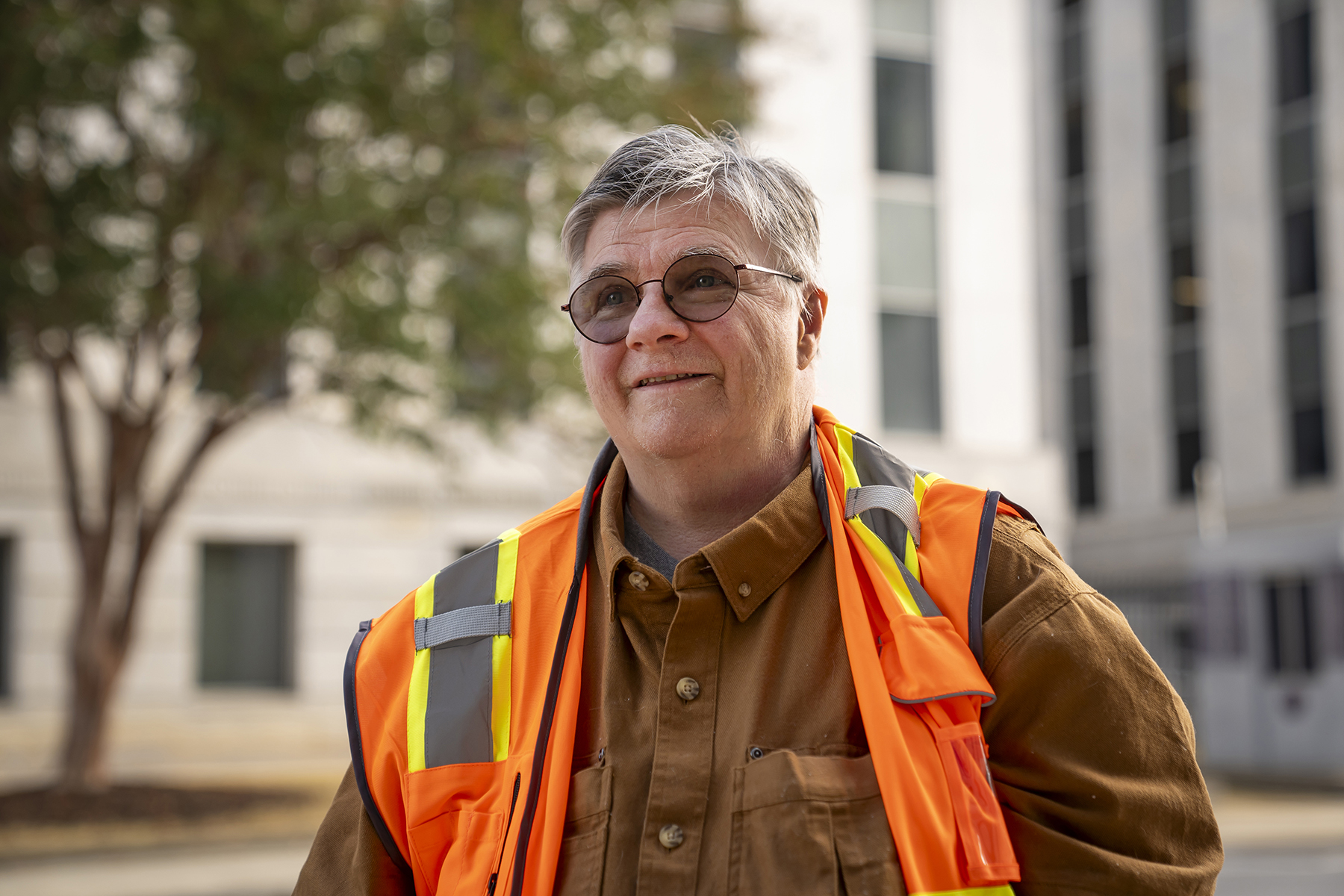 Elisabeth Huhn, wearing a high visibility vest, poses for a portrait.