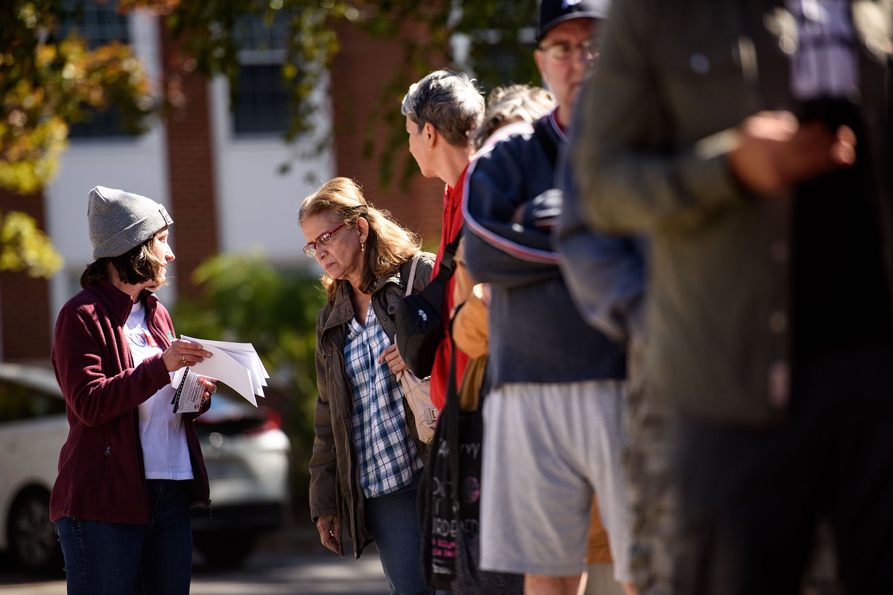 A poll worker talks to a voter while in line outside of an early voting site in Asheville, North Carolina.