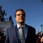 Photographers and journalists surround Matt Gaetz as he leaves the Capitol.