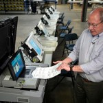 Allegheny County election division manager David Voye demonstrates a voting machine used to process paper ballots at polling places at the elections warehouse.