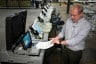 Allegheny County election division manager David Voye demonstrates a voting machine used to process paper ballots at polling places at the elections warehouse.