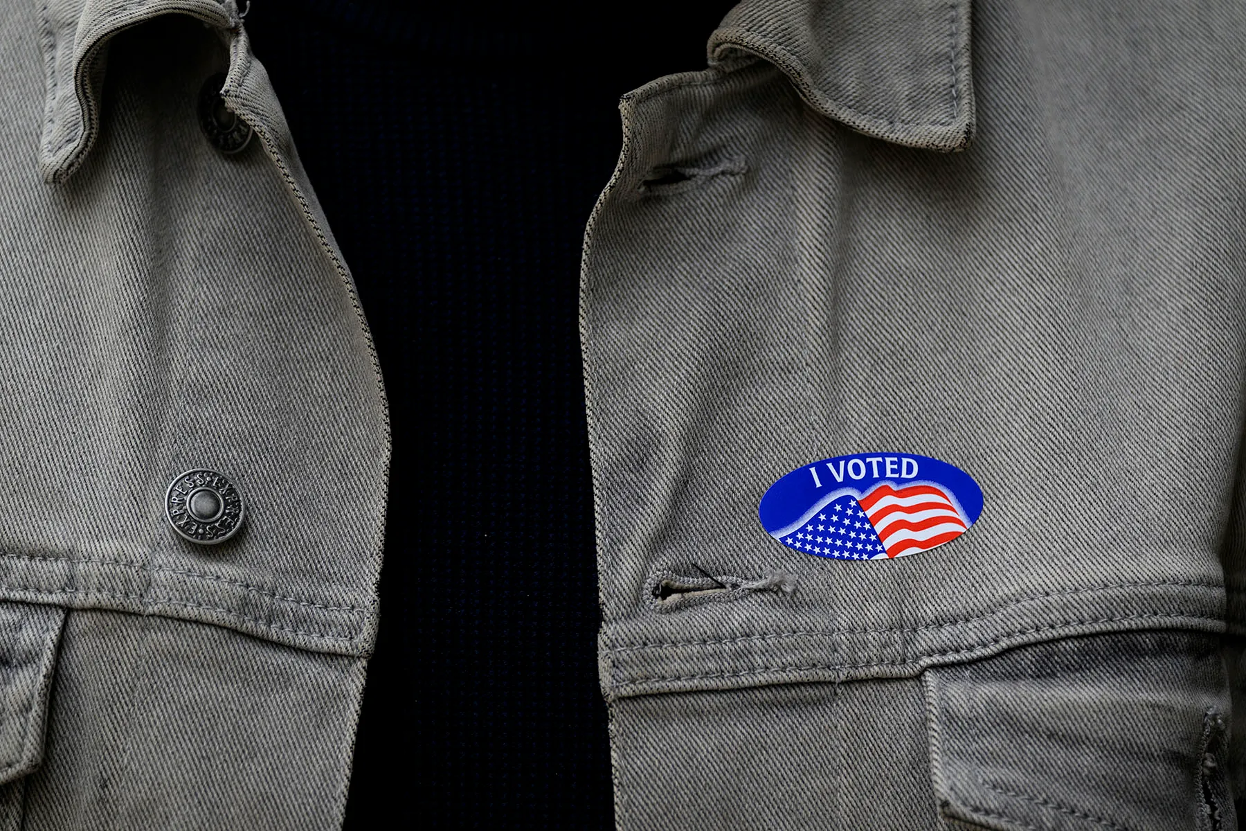 Details of an "I voted" sticker on a jacket as voters line up to apply for their mail-in or absentee ballots outside the Allegheny County Office Building on the last day of early voting.