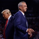 Robert F. Kennedy Jr. walks past Donald Trump during a campaign event in Glendale, Arizona.