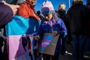 A non-binary child attends a protest outside the Supreme Court during the United States v. Skrmetti arguments.