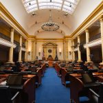 An empty state legislature chambers.