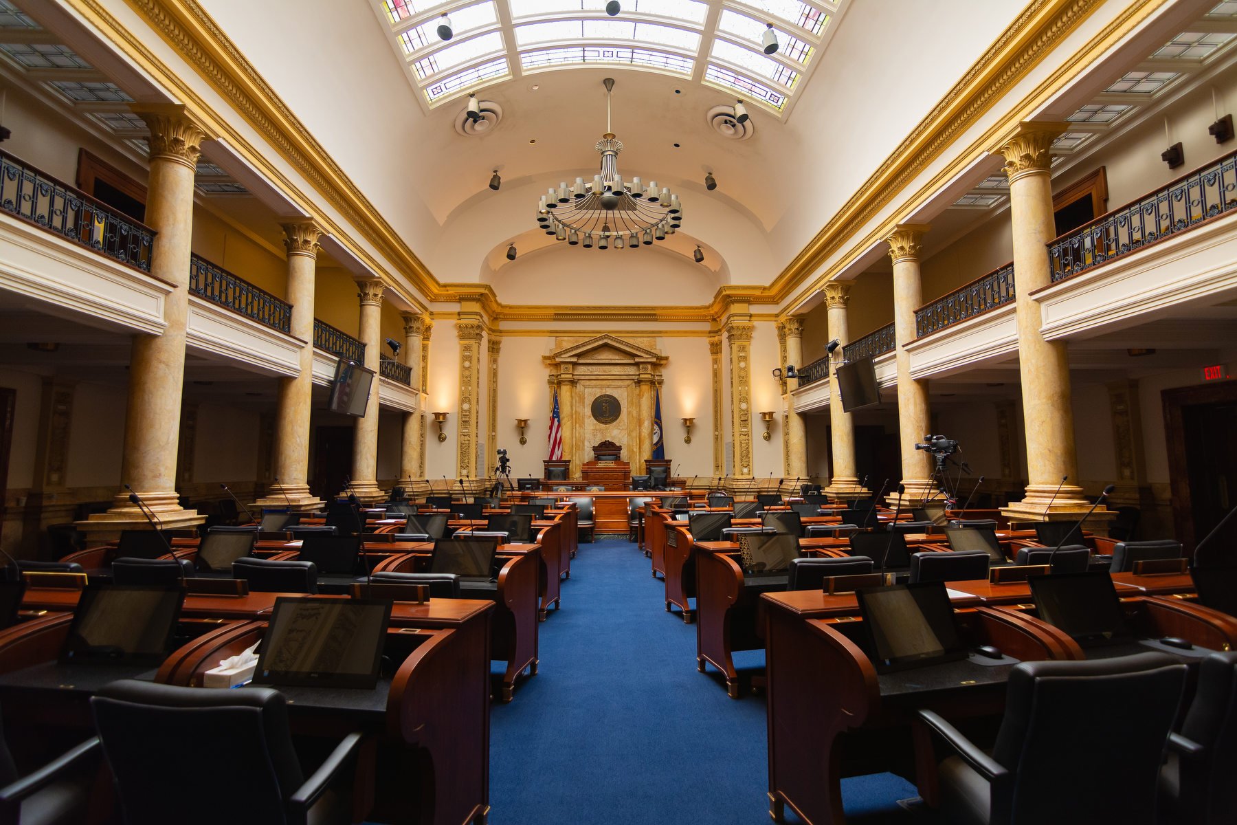 An empty state legislature chambers.