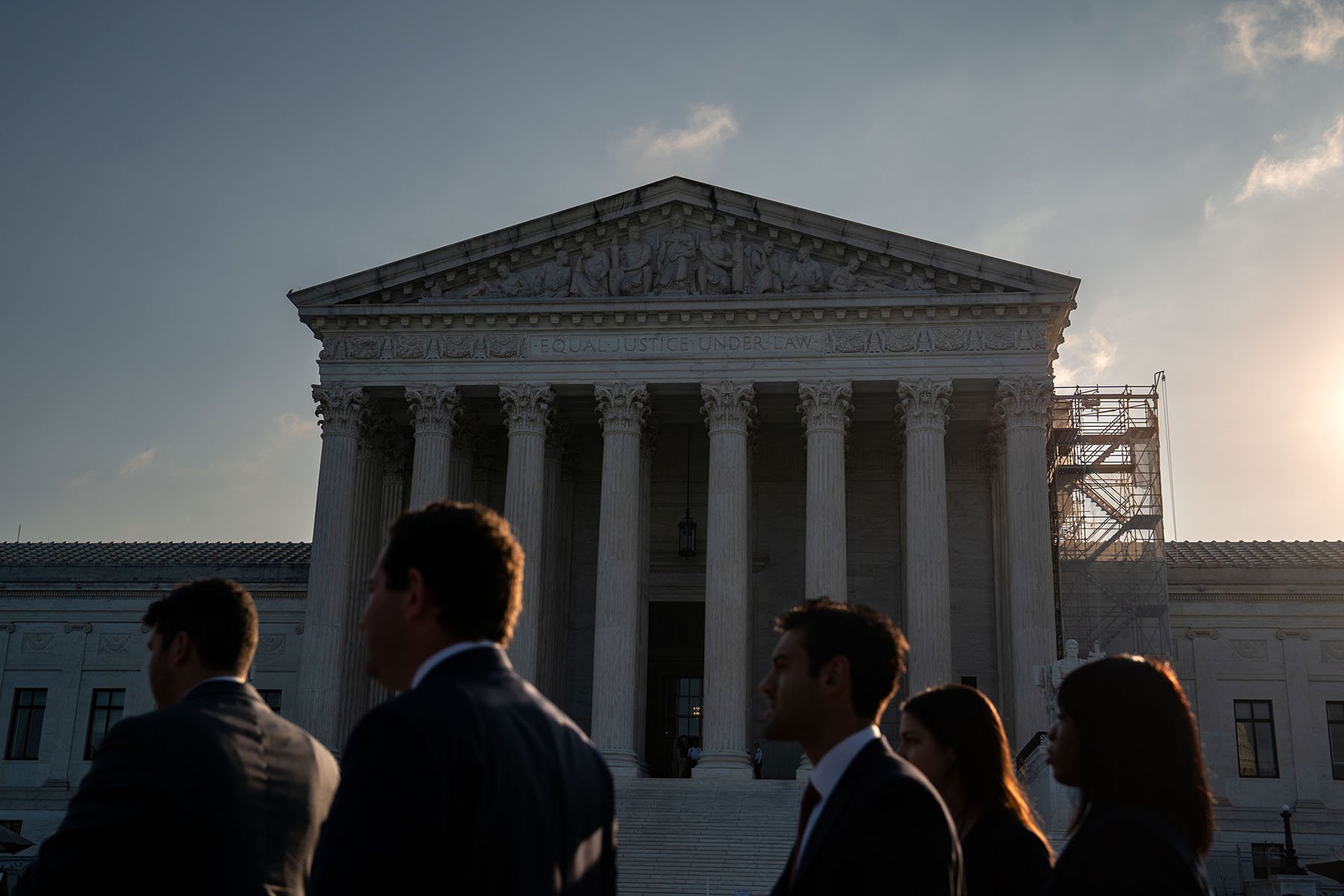 People stand outside the U.S. Supreme Court.