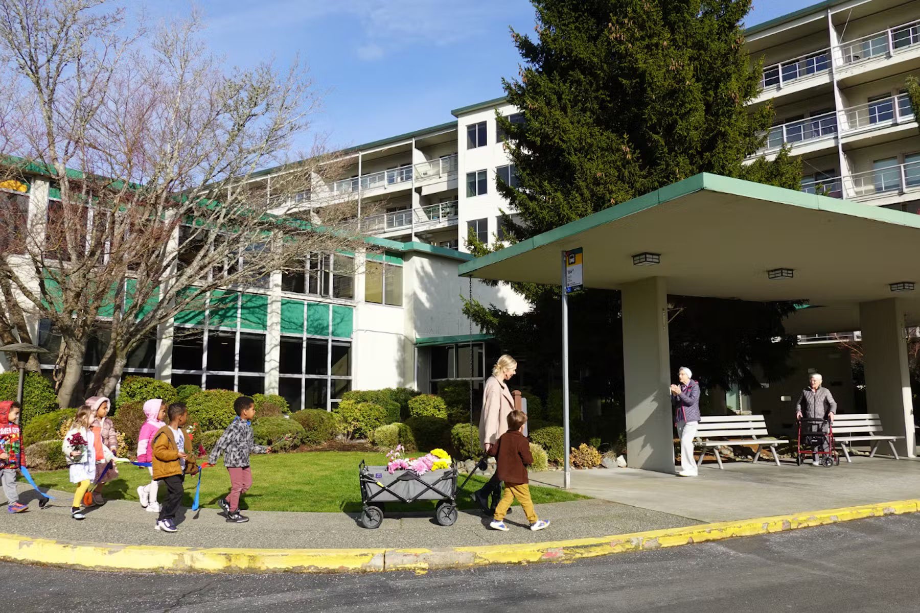 Children from Bezos academy walk to Wesley Homes.