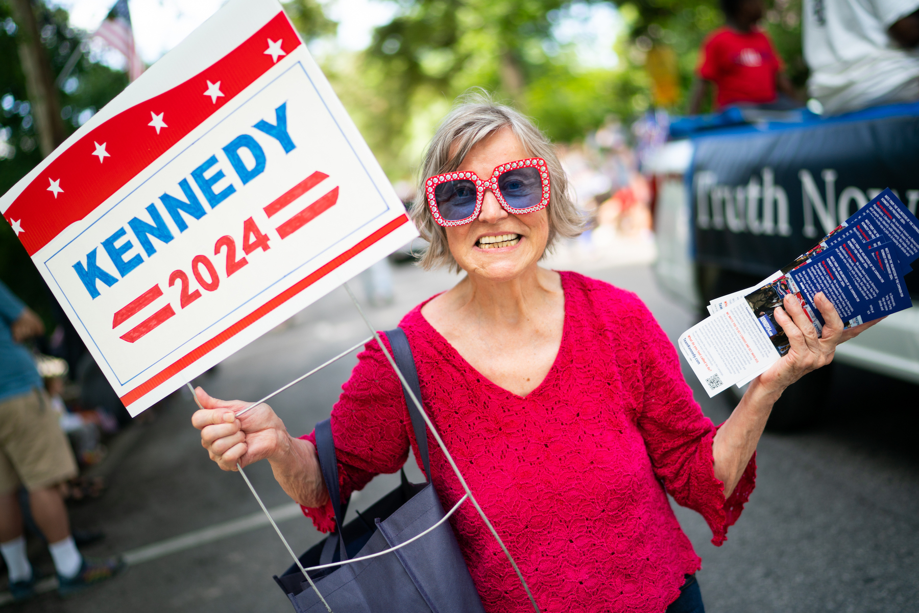 A woman passes out brochures for Robert F. Kennedy Jr. at the Takoma Park, Maryland, 4th of July parade.