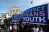 Protesters hold signs in front of the Supreme Court that read 