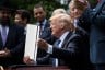 President Trump signs an executive order in the Rose Garden of the White House.