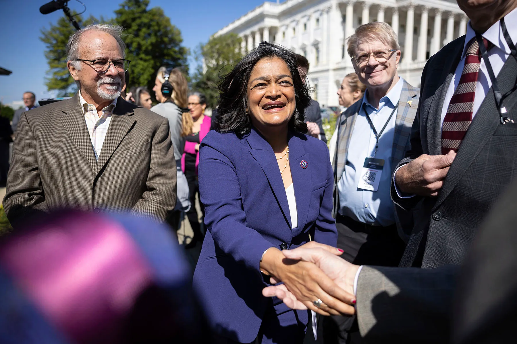 Rep. Pramila Jayapal greets members of Patriotic Millionaires during a press conference on legislation to increase taxation on the wealthy.